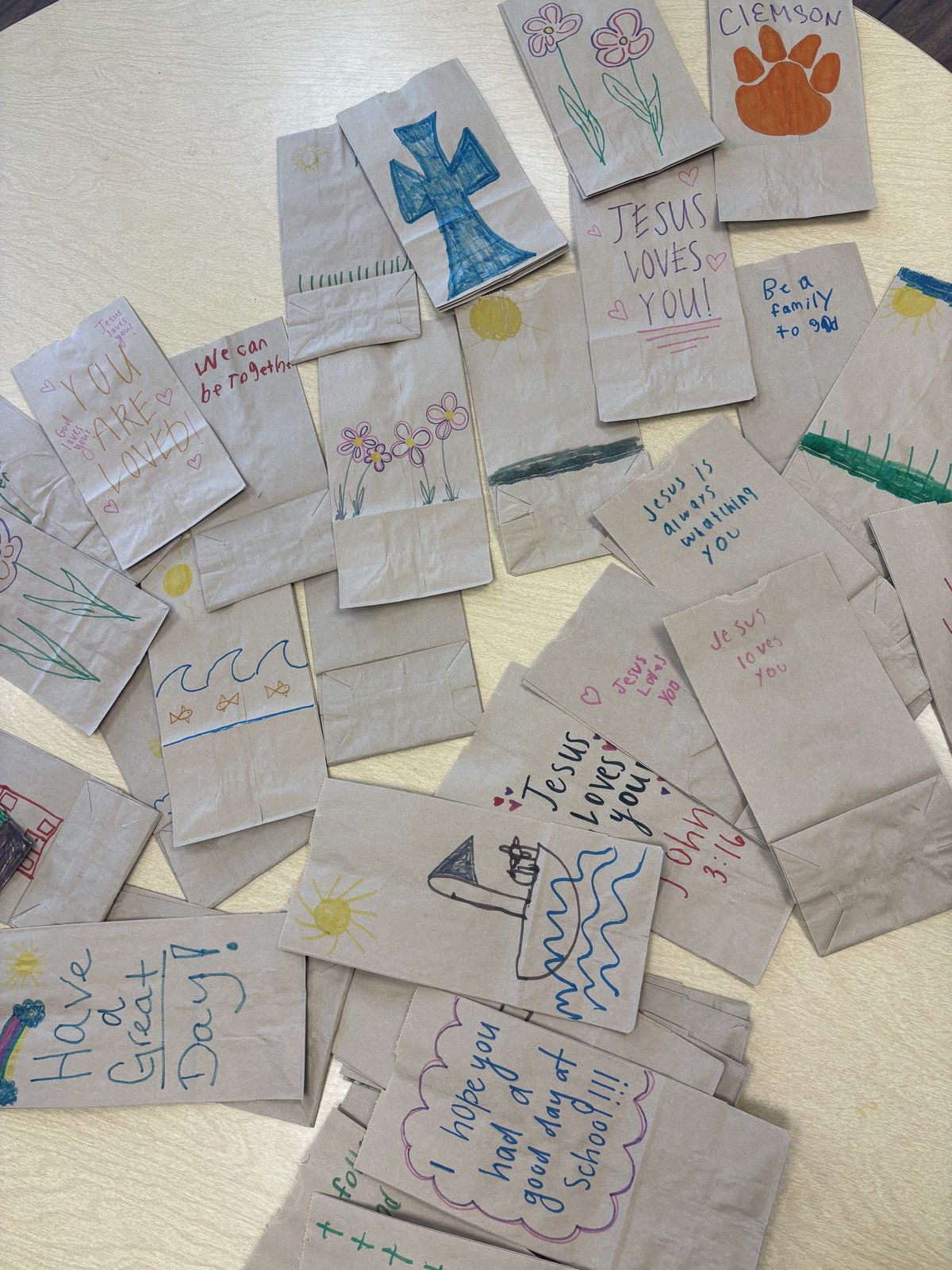 Brown lunch bags decorated with drawings and notes of encouragement for BackPack Buddies