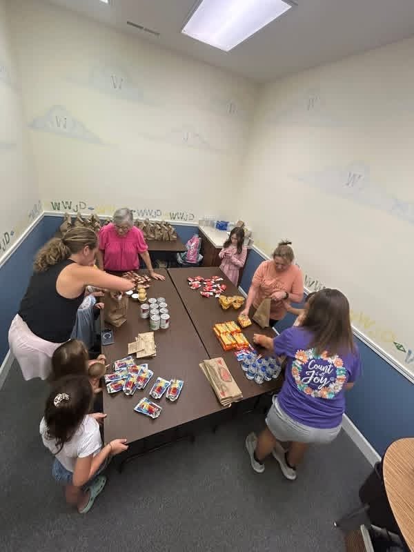 Volunteers packing food bags for BackPack Buddies